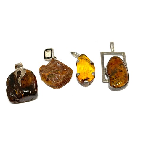 337 - Four silver Amber pendants including modernist (51g)