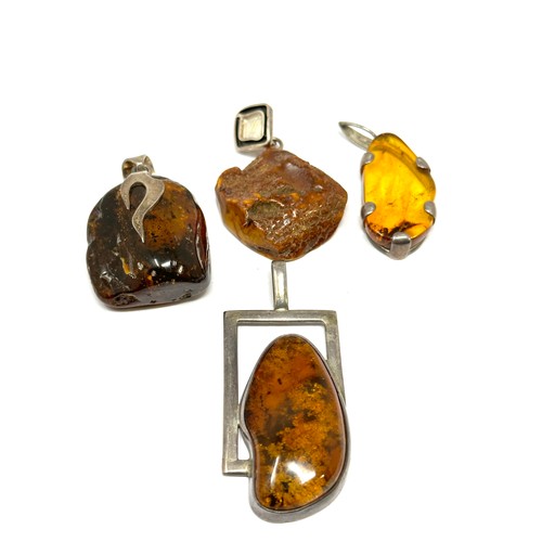 337 - Four silver Amber pendants including modernist (51g)