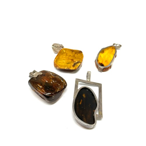 337 - Four silver Amber pendants including modernist (51g)