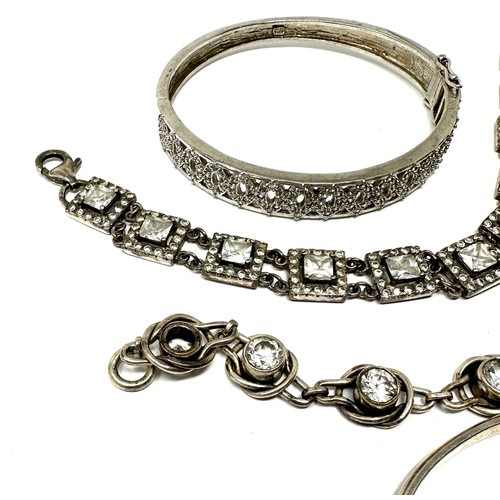 338 - Four silver CZ bracelets & bangles (76g)