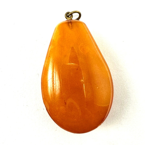 441 - Antique egg yolk Amber Pendant Size Approx at widest points:  43mm x 27mm x 13mm weight 8g