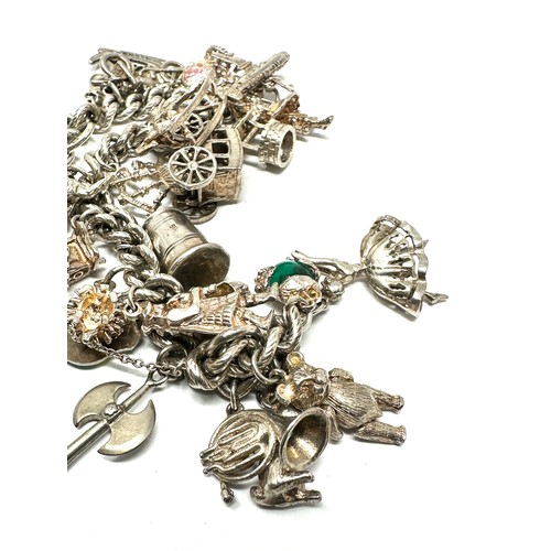 322 - Silver charm bracelet including souvenir charms (83g)