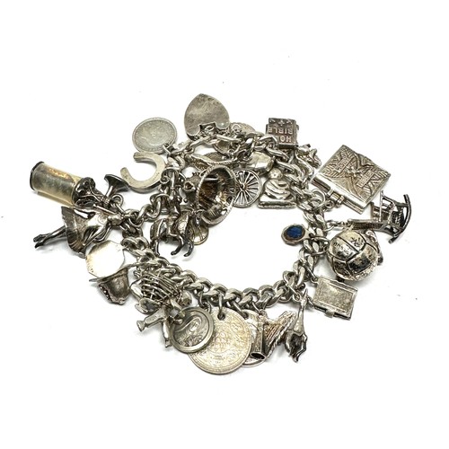 336 - Silver charm bracelet including coin charms (101g)