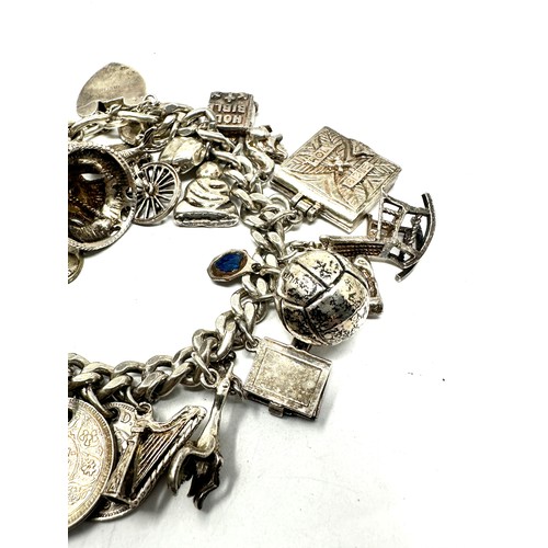 336 - Silver charm bracelet including coin charms (101g)