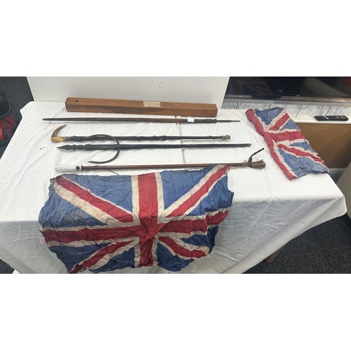 140 - Selection of walking sticks, spear etc 2 union jack flags