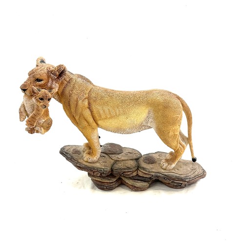 98 - Lioness figure with cub in her mouth, measures approximately 11 inches by 15 inches