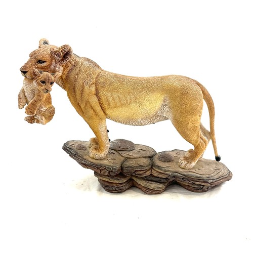 98 - Lioness figure with cub in her mouth, measures approximately 11 inches by 15 inches