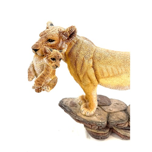 98 - Lioness figure with cub in her mouth, measures approximately 11 inches by 15 inches