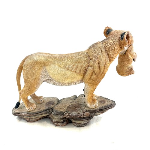 98 - Lioness figure with cub in her mouth, measures approximately 11 inches by 15 inches