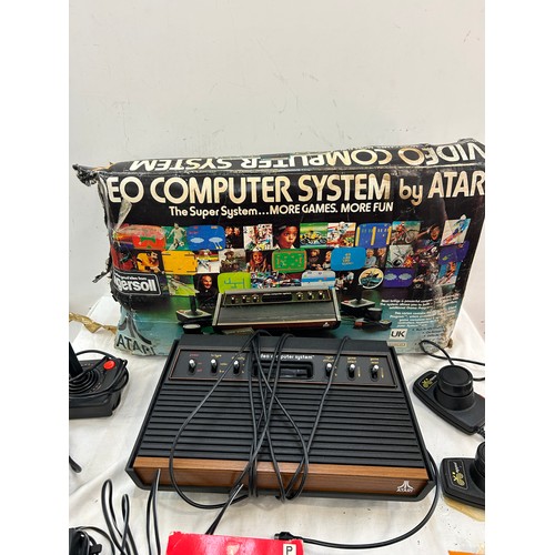 147 - Vintage Atari CX-2600 with combat game program,  pacman and space invaders, joystick and paddles, al... 