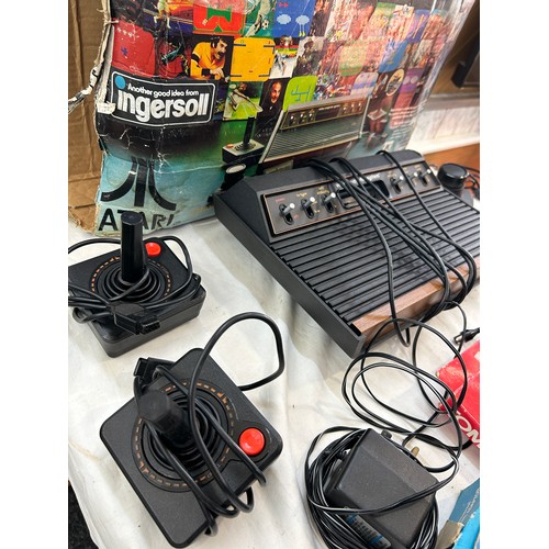 147 - Vintage Atari CX-2600 with combat game program,  pacman and space invaders, joystick and paddles, al... 