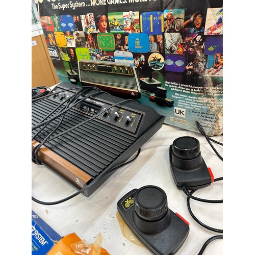 147 - Vintage Atari CX-2600 with combat game program,  pacman and space invaders, joystick and paddles, al... 