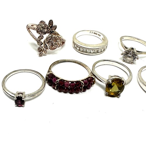 297 - Eight silver stone set rings including garnet and tanzanite (26g)