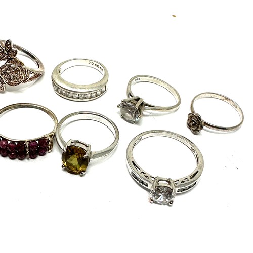 297 - Eight silver stone set rings including garnet and tanzanite (26g)