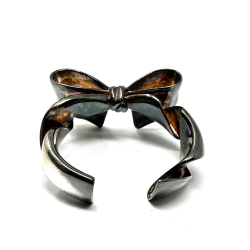 324 - A chunky silver bow design bangle (128g)