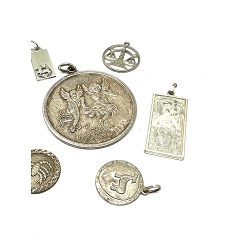 291 - Eight silver assorted zodiac pendants (53g)