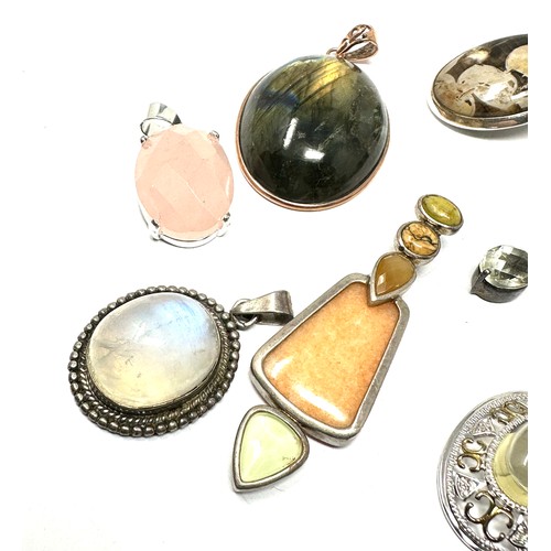 294 - Seven silver mounted gemstone pendants including moonstone and jasper (82g)