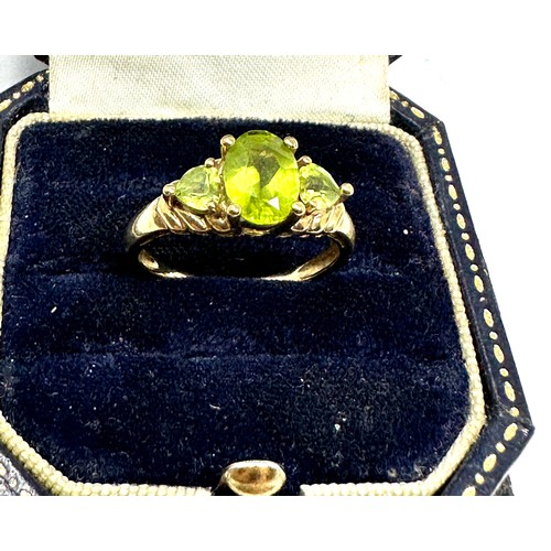 82 - 9ct gold peridot three stone ring (2.3g)