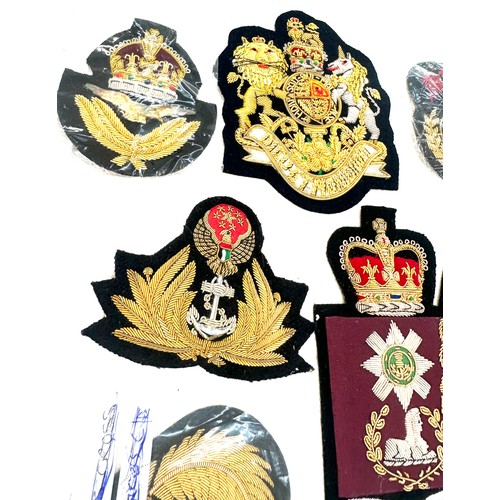 499 - 11 x different hand embroidered gold wire military cap badges/wings