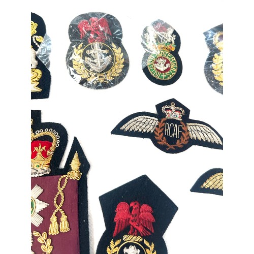 499 - 11 x different hand embroidered gold wire military cap badges/wings