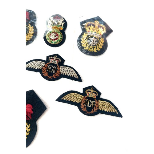 499 - 11 x different hand embroidered gold wire military cap badges/wings