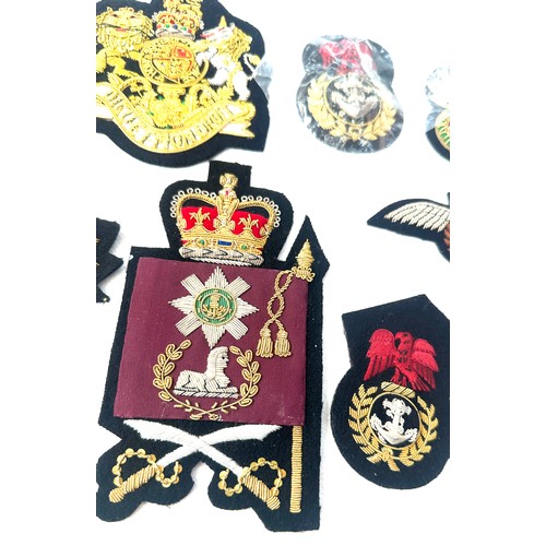 499 - 11 x different hand embroidered gold wire military cap badges/wings