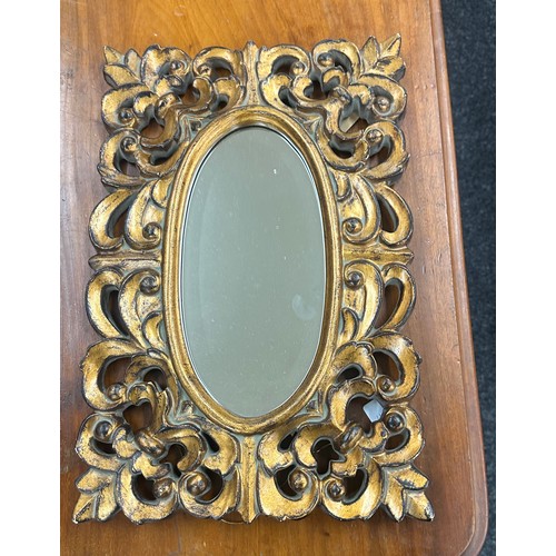 78 - Gilded oval bevelled mirror measures approx 18 x 12 inches