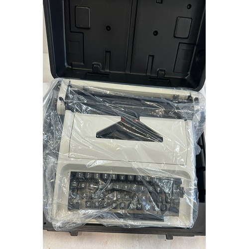 179 - Cased Carina typewriter in box, brand new