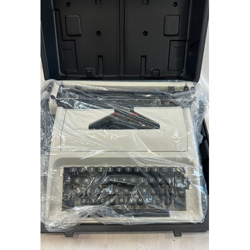 179 - Cased Carina typewriter in box, brand new