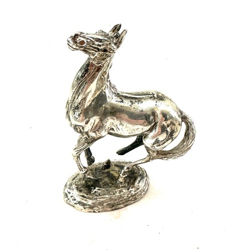 420 - Lorne McKean. 'Playing up'; a silver model of a horse, London import marks for 1975 total weight 595... 