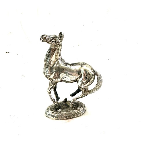 420 - Lorne McKean. 'Playing up'; a silver model of a horse, London import marks for 1975 total weight 595... 