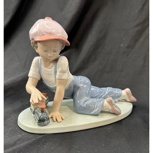 596 - Lladro boy with train, Lladro boy with harmonica both in good overall condition