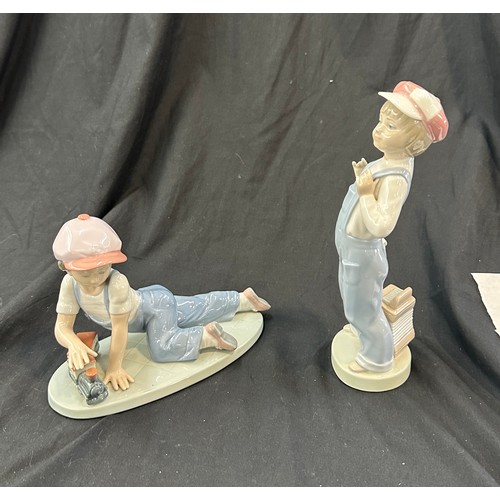 596 - Lladro boy with train, Lladro boy with harmonica both in good overall condition