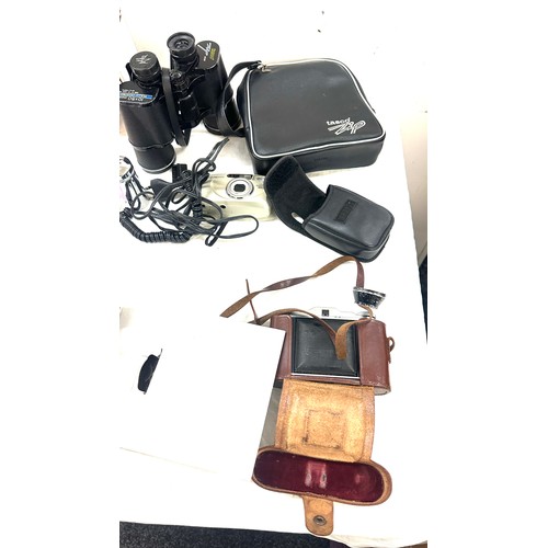 155 - Selection of cameras and binoculars to include Tasco binoculars, Canon sure shot, etc all untested