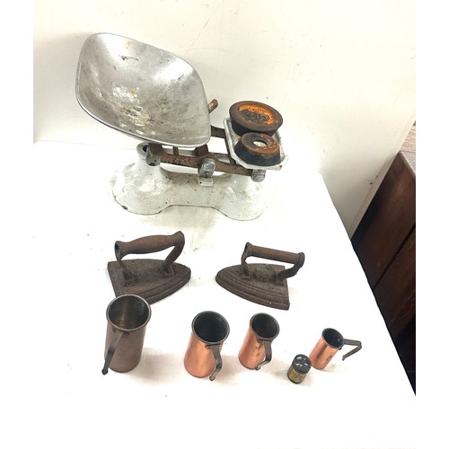 170 - Set of vintage scales and weights, two cast flat irons and copper measuring jugs