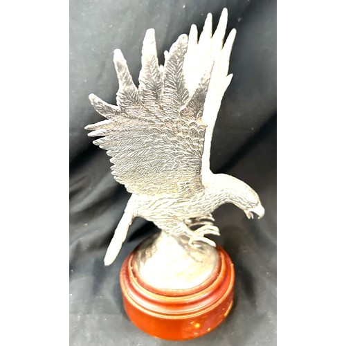 516 - Silver plated eagle mounted on a wooden base height 9 inches tall