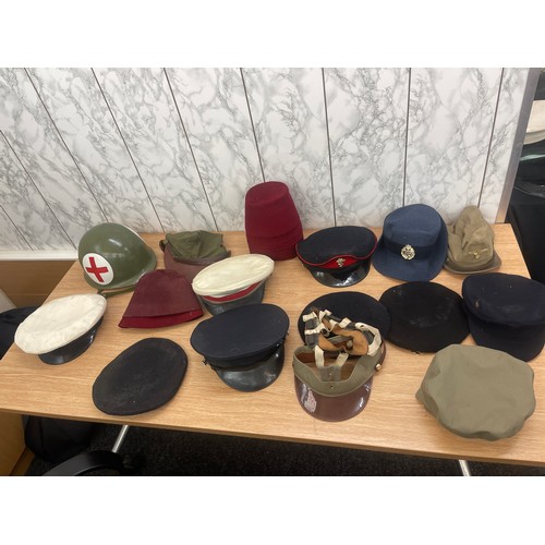 215 - Large selection of vintage and later hats and helmets