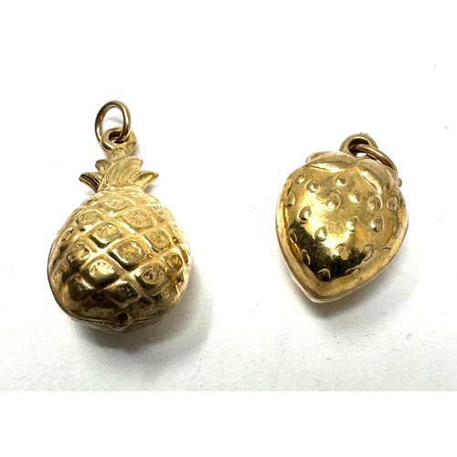 203 - 2x 9ct gold strawberry & pineapple charms (2.5g) ert tested as 9ct gold