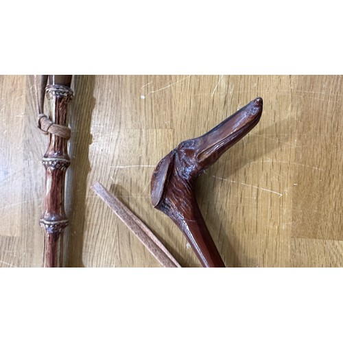 105 - 2 Carved cane shoe horns