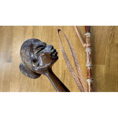 105 - 2 Carved cane shoe horns