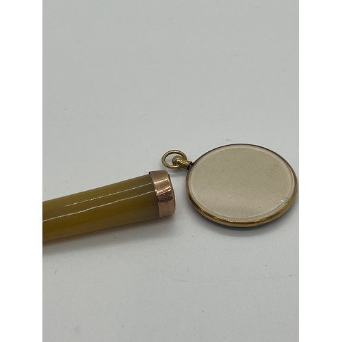 590 - Antique 9ct gold locket and a cheroot holder with 9ct gold mount