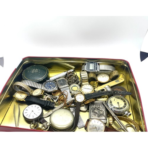 557 - Tin of collectables to include victorian fine silver pocket watch, vesta case, wrist watches, pen kn... 