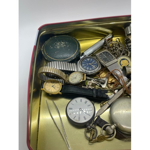 557 - Tin of collectables to include victorian fine silver pocket watch, vesta case, wrist watches, pen kn... 