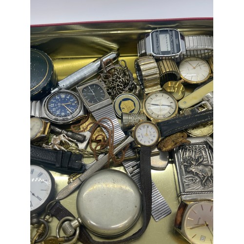 557 - Tin of collectables to include victorian fine silver pocket watch, vesta case, wrist watches, pen kn... 