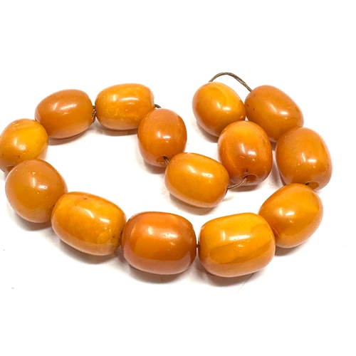 72 - Egg yolk amber beads average size of beads approx 21mm by 16mm weight 50g