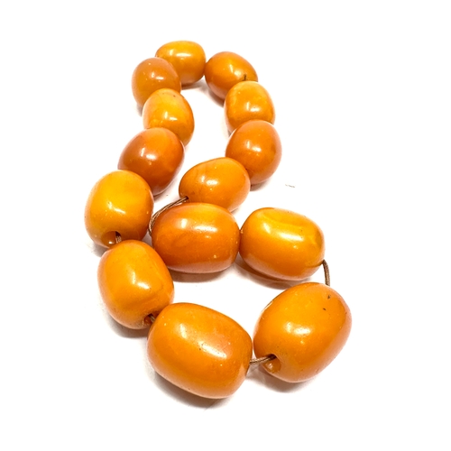 72 - Egg yolk amber beads average size of beads approx 21mm by 16mm weight 50g