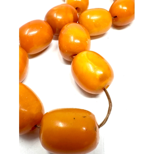 72 - Egg yolk amber beads average size of beads approx 21mm by 16mm weight 50g