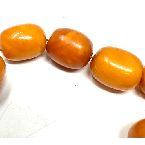 72 - Egg yolk amber beads average size of beads approx 21mm by 16mm weight 50g