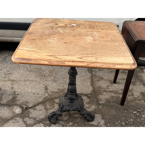 300 - Cast iron base pub table measyres approximately 27 inches tall 26 inches square