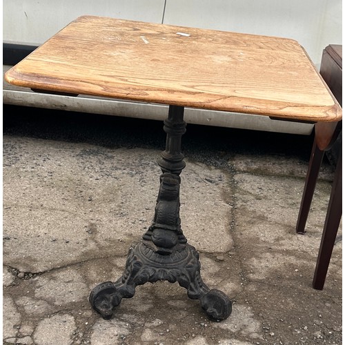 300 - Cast iron base pub table measyres approximately 27 inches tall 26 inches square